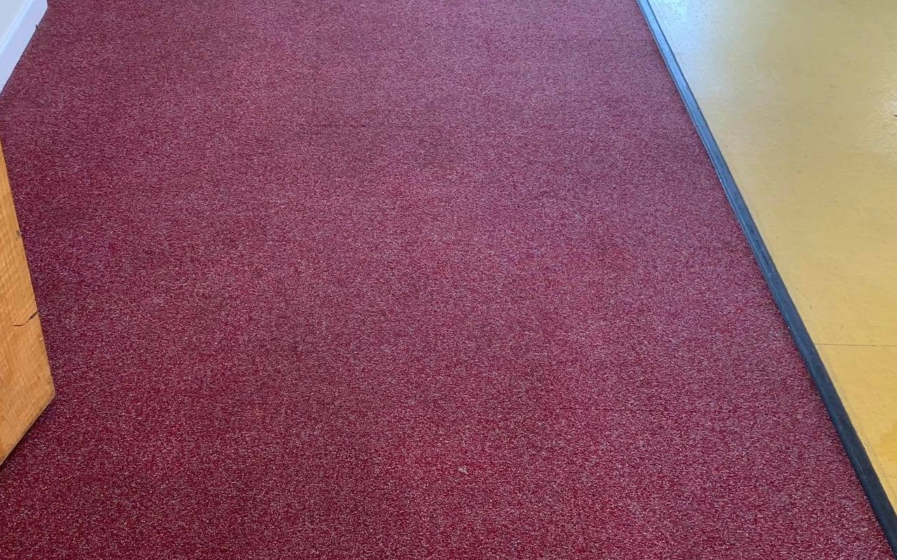 The same red carpet after the coffee stain was removed