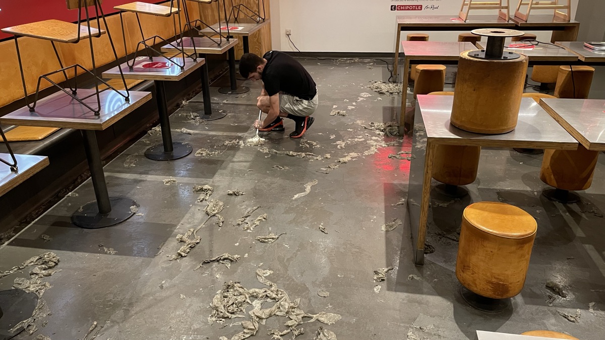 The restaurant floor mid-job with the old sealer being stripped back