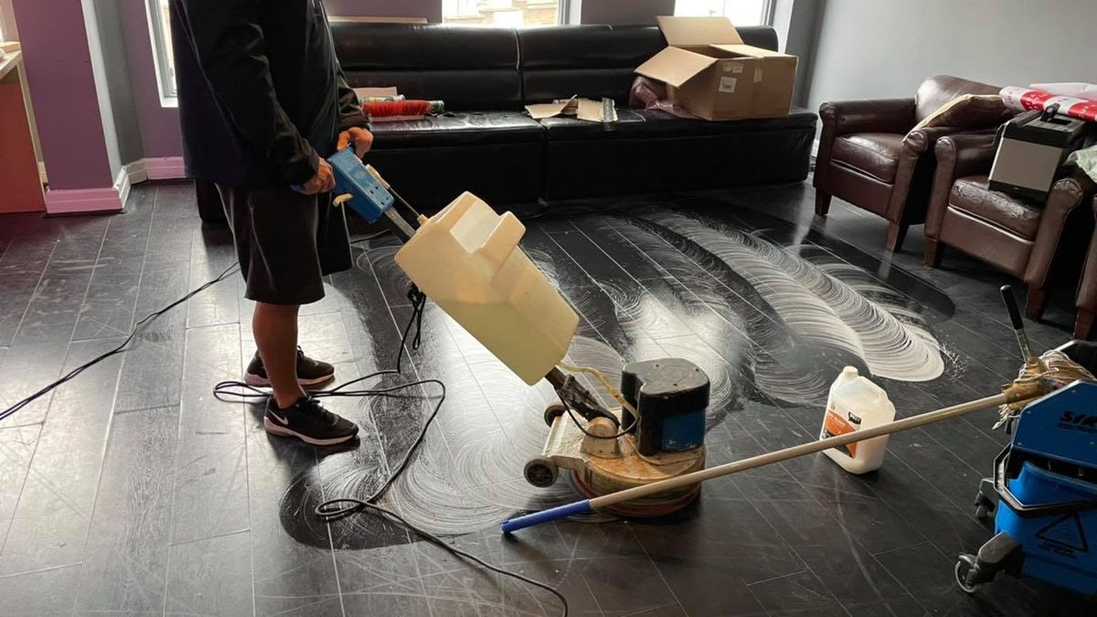 Jay working a rotary buffer across a commercial wood floor