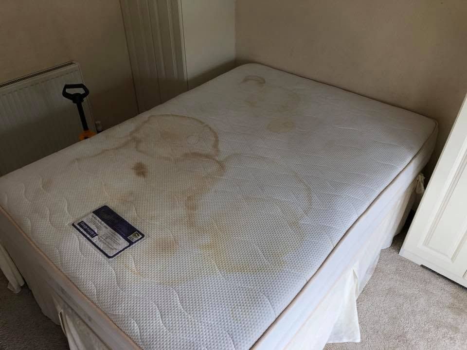 A heavily stained mattress before cleaning