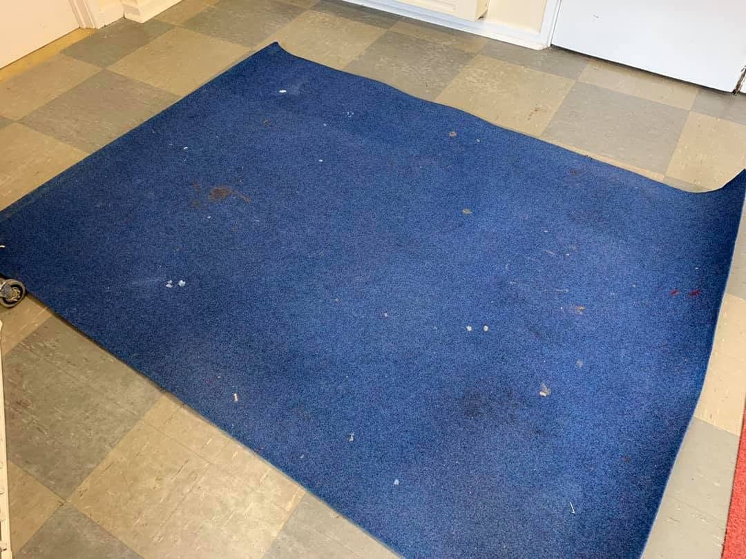 A blue rug before cleaning