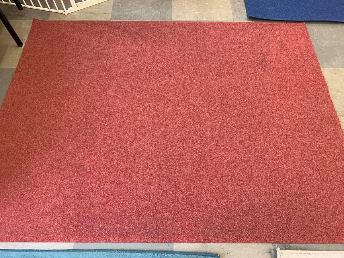The same red rug after cleaning by Jay's Cleaning