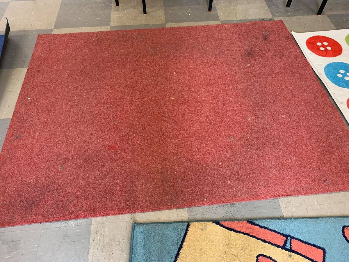 A red rug before cleaning