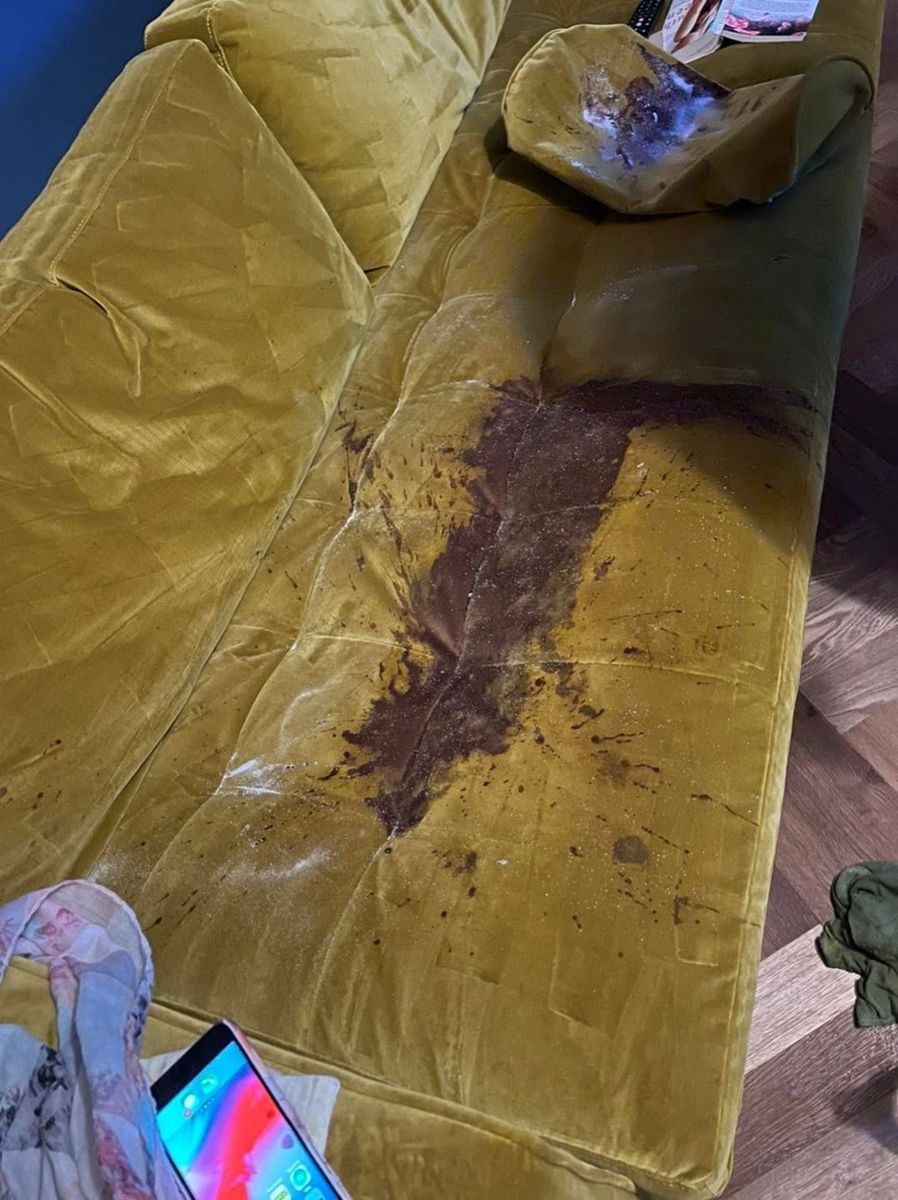A red wine stain on a sofa before cleaning by Jay's Cleaning
